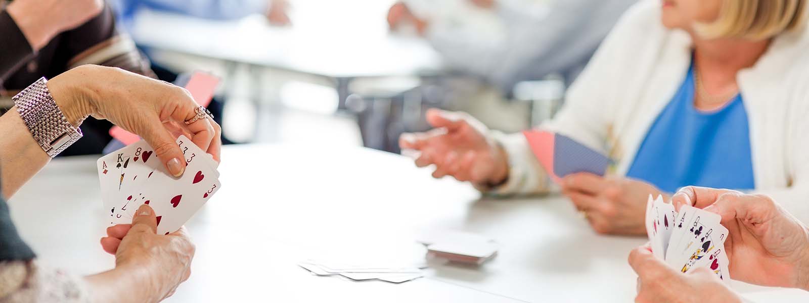 Seniors playing cards in community center